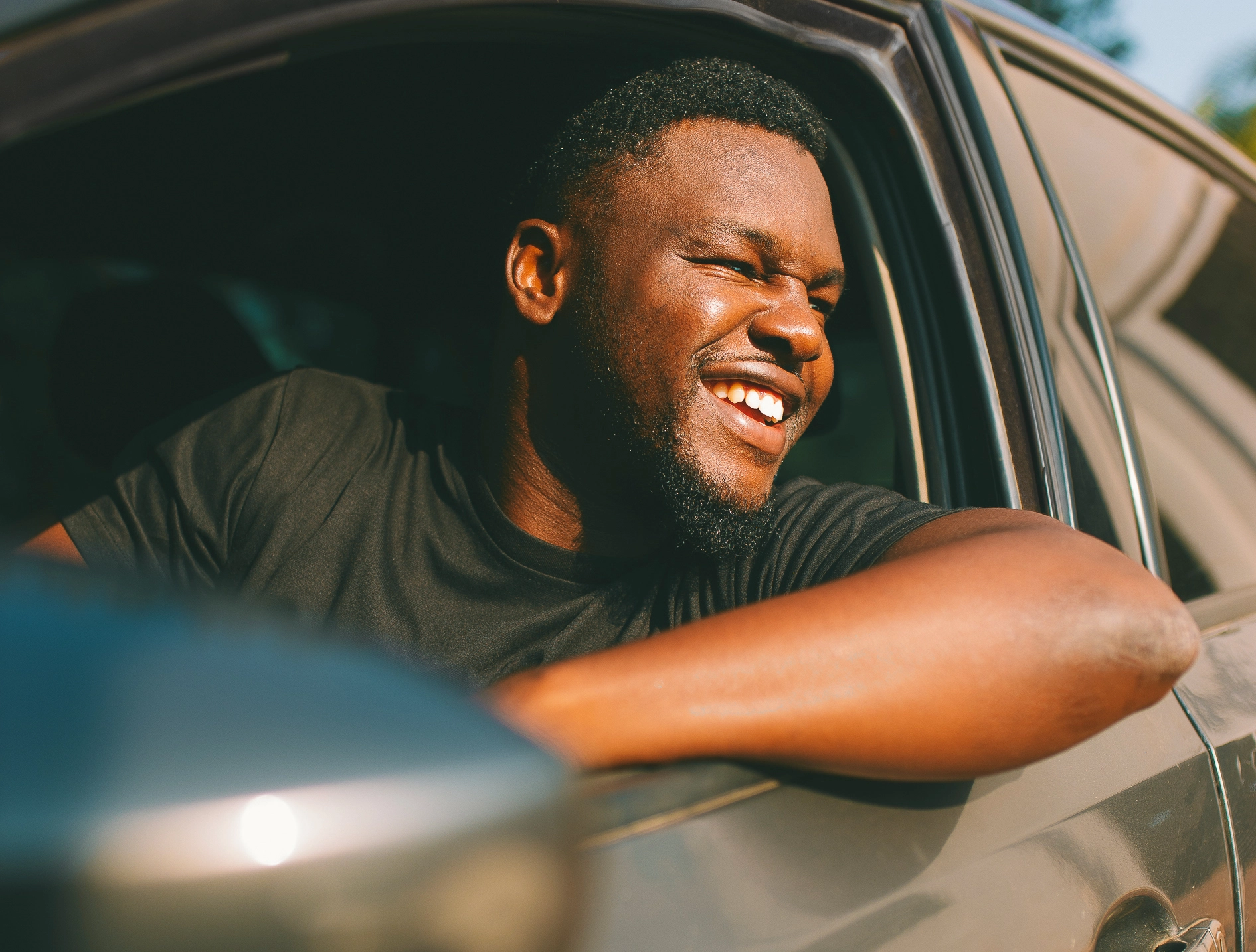 Dryver smiling in car