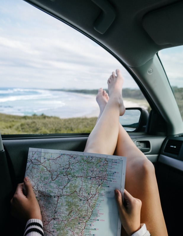 Woman reading map in her car